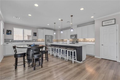 Kitchen with a kitchen breakfast bar, crown moldin