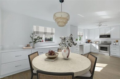 Staged-Dining space featuring light wood-style flooring and a ceiling fan