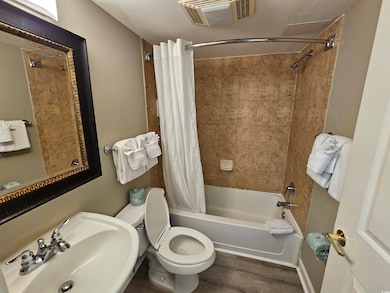 Bathroom featuring a sink, toilet, visible vents, 