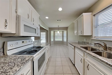 Kitchen featuring light tile patterned floors, whi