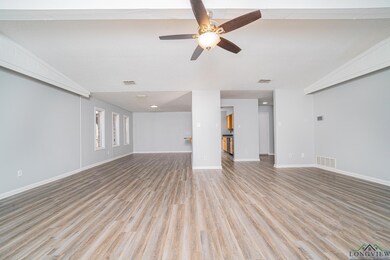 Unfurnished living room featuring a textured ceili