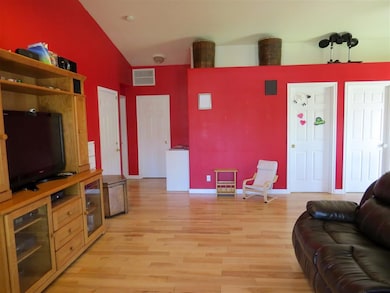 Features wide-plank handscraped hardwood flooring,