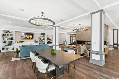 Dining room featuring wood finished floors, a chan