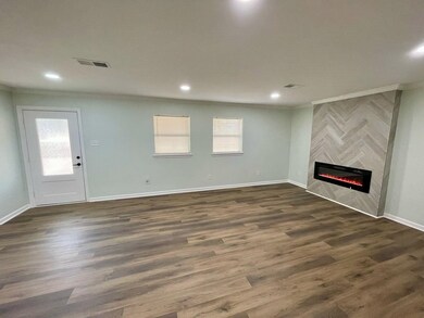 Unfurnished living room with a tiled fireplace, or