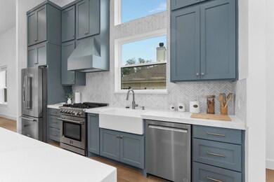 Kitchen with premium appliances, custom exhaust h