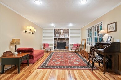 Family Room with fireplace off the kitchen and breakfast area, opens onto covered deck
