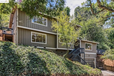Rear view of house featuring stairway and an attached garage