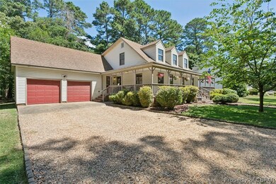 Farmhouse/ Cape Cod style house featuring a garage