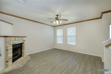 Large living room with fireplace & ceiling fan
