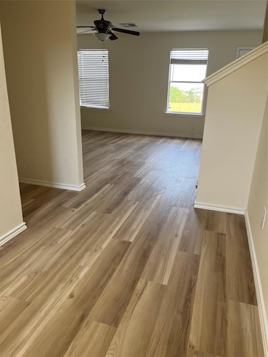 Spare room with baseboards, ceiling fan, wood fin