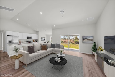 Living room with light wood finished floors, visib