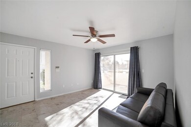 LIVING ROOM WITH LED CEILING FAN AND PATIO ACCESS