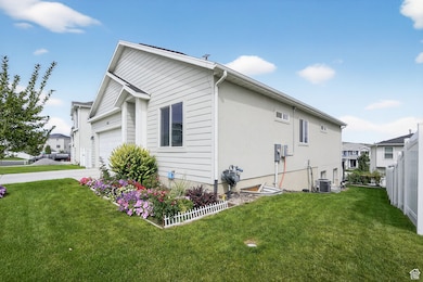 View of side of home featuring driveway and a garage