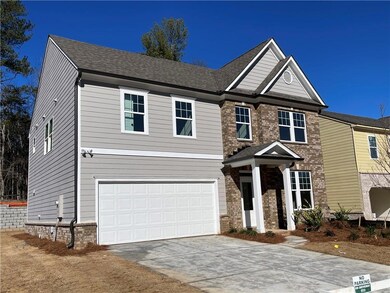 View of front of house featuring driveway, a shing