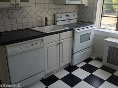Kitchen. Striking black and white tile floor gives this lovely kitchen a pop of personality!