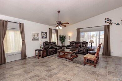 Tiled living room featuring vaulted ceiling and ce