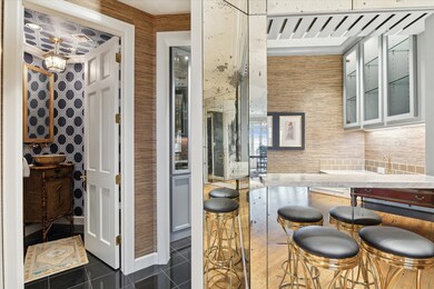 The chic powder room and wet bar add wonderful con