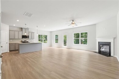 Unfurnished living room with ceiling fan, light wood-type flooring, recessed lighting, a fireplace with flush hearth, and baseboards
