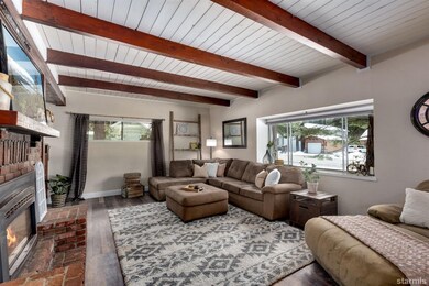 Living Room w/ open beam ceiling gas fireplace