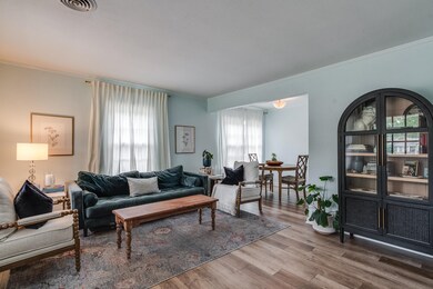 Living room featuring ornamental molding and wood-