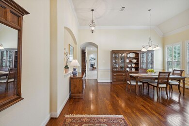 Dining room featuring lofted ceiling, dark wood-ty