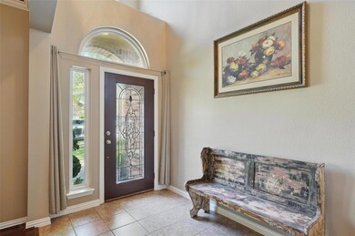 Foyer entrance with tile patterned flooring and ba