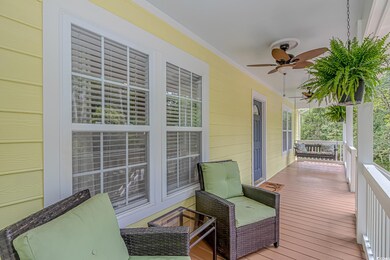 Wooden deck featuring a porch and ceiling fan