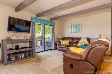Open living area leads to a lakeside deck for outs