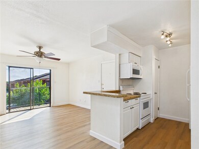 Kitchen featuring white appliances, light wood-typ