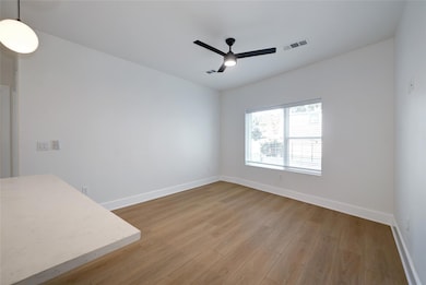 Spare room with a ceiling fan, wood finished floo