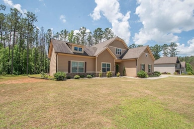 Craftsman inspired home with a front lawn, stone siding, and a shingled roof