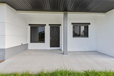 View of exterior entry with stucco siding