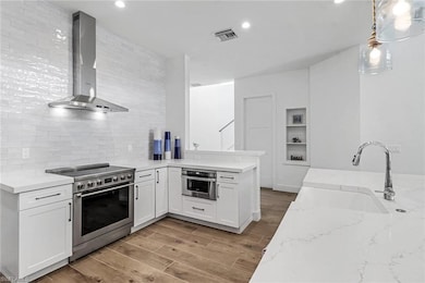 Kitchen featuring stainless steel appliances, wall