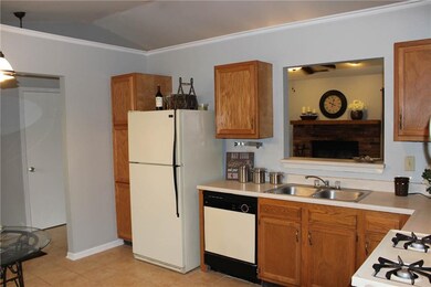 This photo shows off the cathedral ceiling that runs through the entry, kitchen and great room.  This makes for attractive architectural detail.  There is a pass through into the great room so you won't miss a thing with family or friends while enter