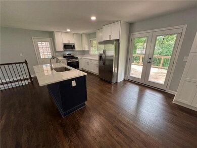 Kitchen with appliances with stainless steel finishes, a sink, light countertops, plenty of natural light, and recessed lighting