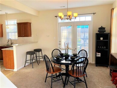 Dining room and breakfast bar with view of back pa
