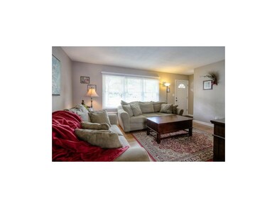VIEW OF LIGHT AND BRIGHT LIVING ROOM FROM DINING A