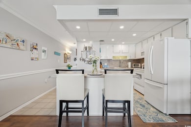 Kitchen with tasteful backsplash, visible vents, a