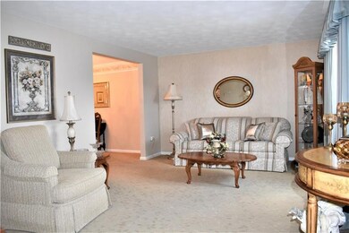 New wall-to-wall is tone on tone sculpted carpet.  Custom window shades. String wall covering on accent wall.