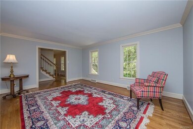 Large living room with hardwood floors and crown m
