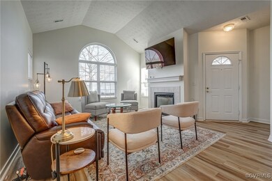 Living room featuring visible vents, light wood fi