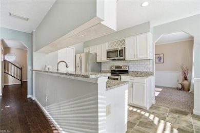Bright White Kitchen with stainless steel appliances and granite countertops