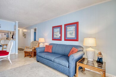 Living room featuring tile patterned flooring, a t