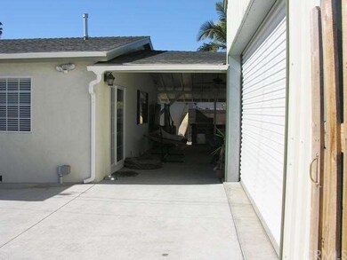Side of house, garage exterior & covered patio vie
