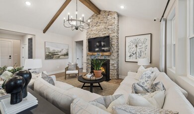 Great room with stained ceiling beams & vaulted ceiling