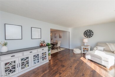 Living room with dark hardwood / wood-style flooring