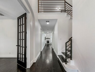 Through the foyer is this incredible entryway. Boasting high ceilings, stunning fireplace, and a gorgeous contemporary staircase with wrought iron railing!