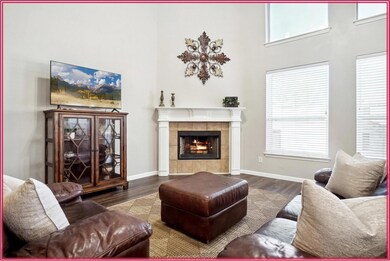 Living room with a towering ceiling, wood-type flo