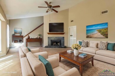 Living room with a fireplace, high vaulted ceiling