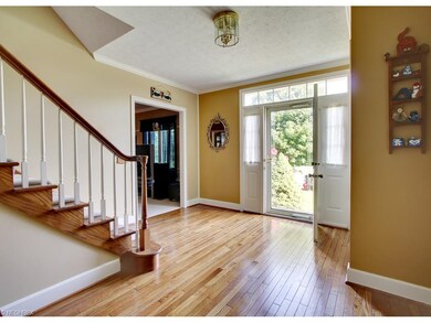 This welcoming foyer offers hardwood floors, crown
